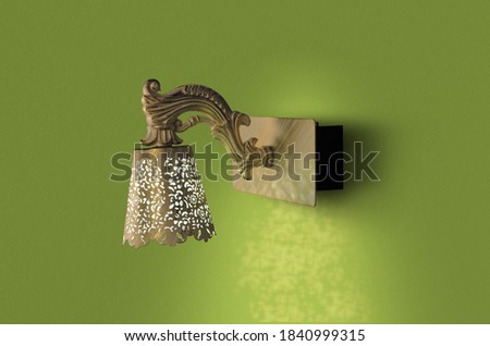 Antique metal lamp on green wall background