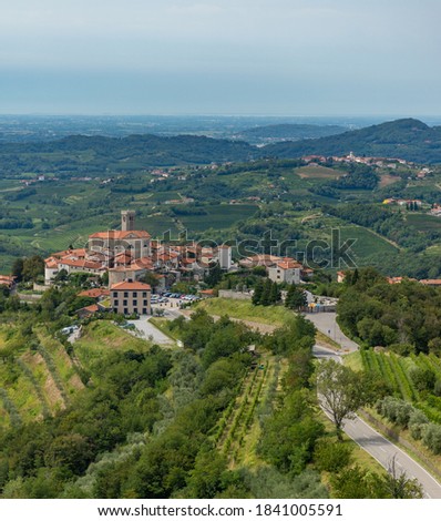 A picture of the town of Šmartno surrounded by vineyards and landscape.