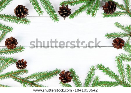 Christmas wooden background. Spruce branch and cone. Copy space. Postcard.Christmas tree. Fir branches.Flat lay