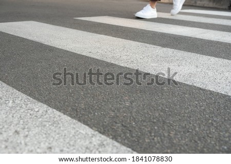 female feet crossing the crosswalk
