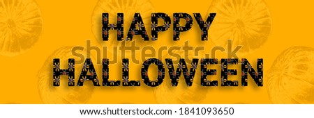 Phrase Happy halloween written on golden background. Marmalade spiders on black background inside the letters.