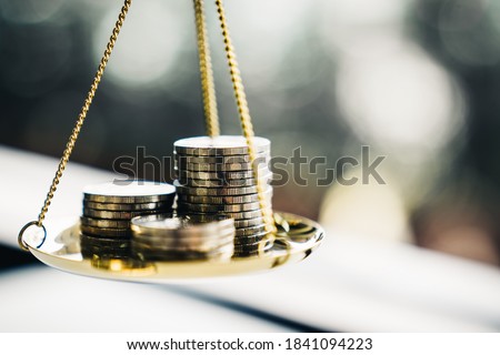 Coins stack with balance scale. Money management, financial plan, time value of money, business idea and Creative ideas for saving money concept.  Royalty-Free Stock Photo #1841094223