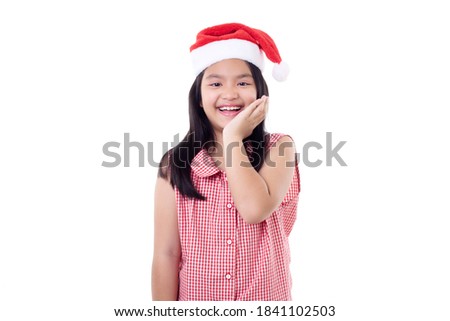 Happy Little Asian girl wearing Santa hat Pointed to the side on white background Christmas concept.