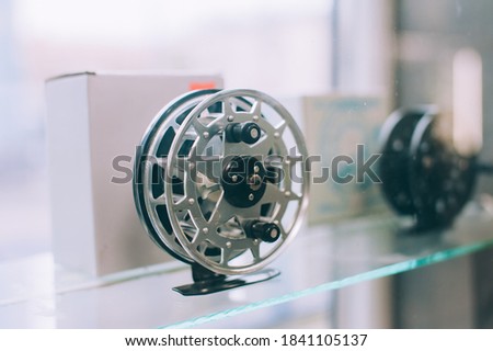 A reel for a fishing rod on a shop window
