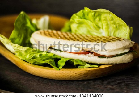 sandwiches with salad in wood plate