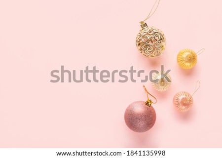 Christmas balls and lightbox with the text "Happy New Year" on a pink background. Flat lay