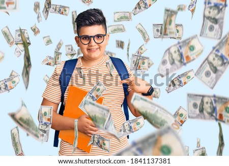 Little boy kid wearing student backpack holding books pointing finger to one self smiling happy and proud