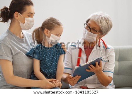 Doctor, child and mother wearing facemasks during coronavirus and flu outbreak. Virus protection. COVID-2019. Taking on masks.