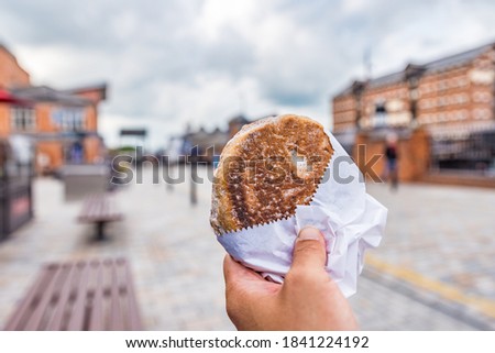 Traditional Welsh cake with Gloucester townscape background.