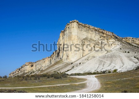 White limestone mountain in crimea, bottom view against a blue sky