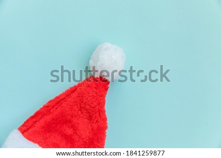 Simply minimal design Christmas Santa Claus hat isolated on blue pastel colorful trendy background. Christmas New Year december time for celebration concept. Flat lay top view copy space