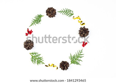 Christmas wreath. Christmas and New Year holidays decorations with fir branches, pine cones, red berries and golden confetti.