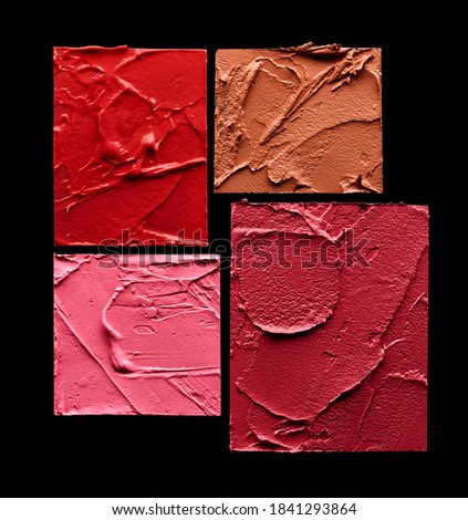 Lipstick swatches in red, pink and beige colors isolated on black background