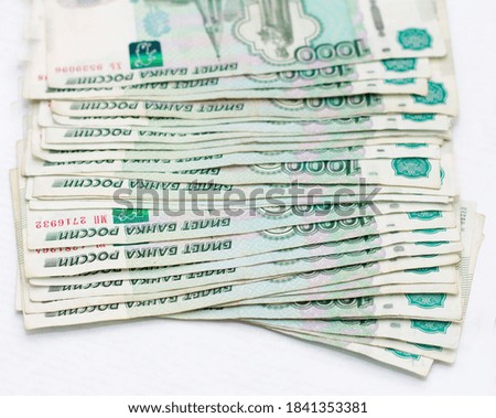 Scattered Russian 1000 rubles banknotes closeup isolated on the white background