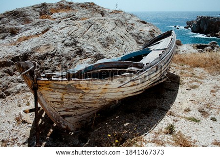 old boat in folegandros with the sea in the background