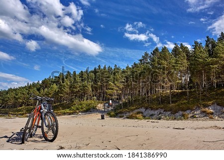 Bicycles parked on a Baltic Sea beach in summer.