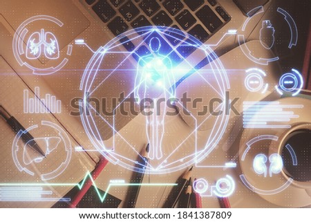 Education hologram drawings over computer on the desktop background. Top view. Multi exposure.