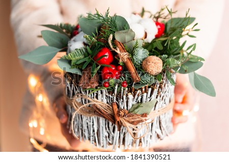Christmas decoration with carnations, chrysanthemums santini, brunia and fir. Christmas spirit and mood Royalty-Free Stock Photo #1841390521