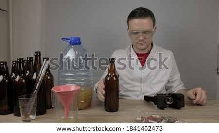 a young brewer prepares products and checks the quality of the equipment and the quality of honey beer brewed at home
