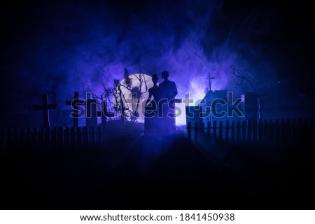 Horror Halloween concept. Scary zombie bride on a night cemetery. Selective focus