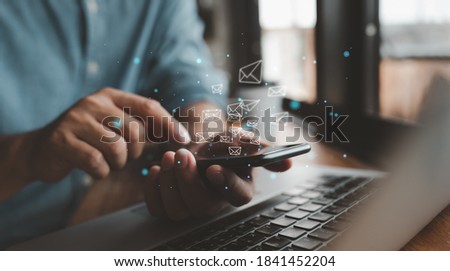 Man hand use smartphone with email icons being sent out. Communication business technology. Sending a message with your phone. Royalty-Free Stock Photo #1841452204