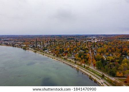 Aerial photo of Traverse City Michigan during the fall. Autumn colors fill the trees creating a beautiful, colorful landscape. 