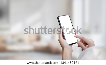 Close up view of female hands using smartphone in blurred background, clipping path