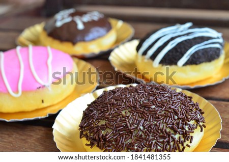 Colorful deilicous donuts at the wood table