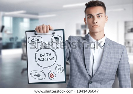Business, Technology, Internet and network concept. Young businessman working on a virtual screen of the future and sees the inscription: Data mining
