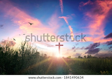 Easter concept: cross on sunset sky background