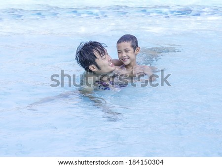 father and son feel happy in the pool.