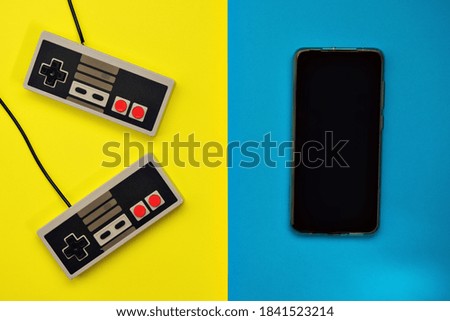 cell phone retro console controls and background in yellow and blue colors