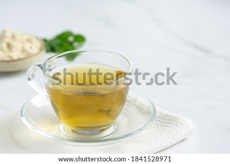 Stevia tea in a glass cup on the table