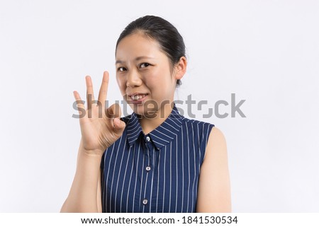 A young Asian girl in front of the camera