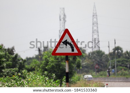 Left curve traffic sign on the side of National Highway Road, India