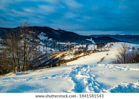 winter season. snow on top of the mountain on a background of mountains. morning dawn. new year, christmas,