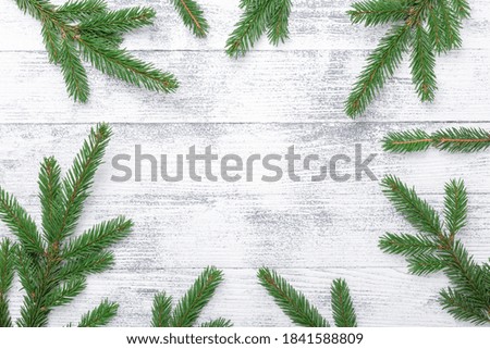 Christmas background with fir tree branch on wooden table. Eco natural frame. Top view. Copy space - Image