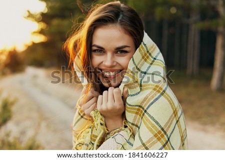 Cheerful woman in plaid blanket outdoors cropped view of fresh air Royalty-Free Stock Photo #1841606227
