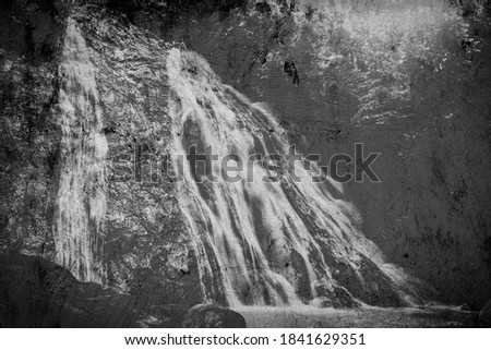 Monochrome painted waterfall on cement background.