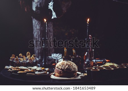cookies and desserts on a dark background. sweets for halloween celebration. table decoration for the holiday