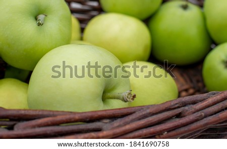 Yellow / White Transparent apples in the dark brown wicker basket on white table Royalty-Free Stock Photo #1841690758
