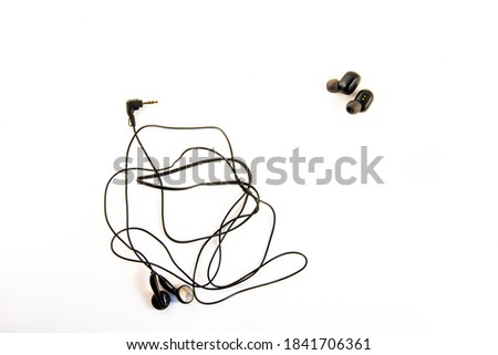 Wireless headphones and wired headphones on a white background