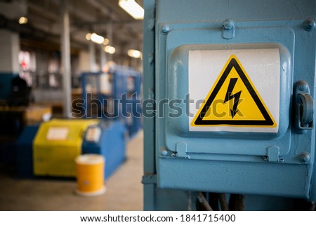 Yellow sigh danger electric shock with lightning in triangle on a metal electric distribution box. 