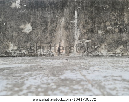 Grey textured wall, dark edges background.