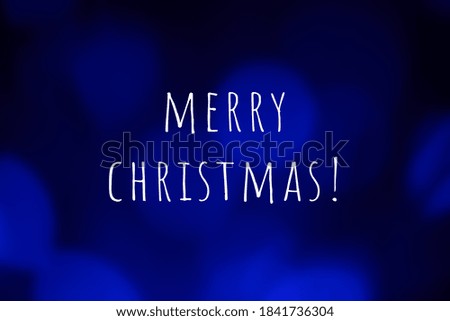 Merry christmas text on abstract blue lights bokeh background