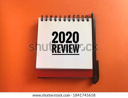 Word 2020 review written on the notepad. Annual performance evaluation concept Royalty-Free Stock Photo #1841745658