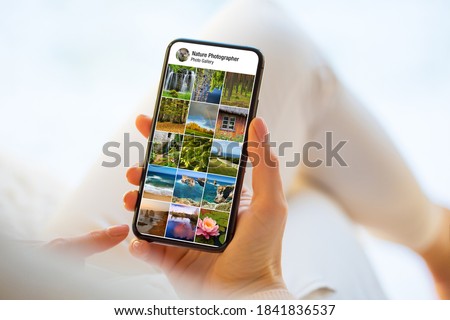 Person looking at nature and landscape photographs on mobile phone