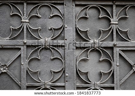 The texture of old metal doors. A pattern of metal parts. Iron door