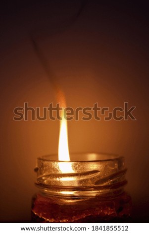 Flame and smoke from the candle