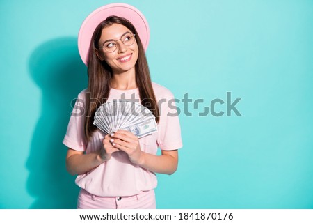 Portrait of her she nice attractive curious cheerful girl holding in hands fan cash salary deposit loan looking copy space isolated bright vivid shine vibrant green turquoise color background